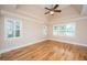 Serene main bedroom with hardwood floors, a tray ceiling, and an abundance of natural light at 8725 Herons Walk, North Charleston, SC 29420