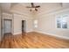 Large main bedroom with hardwood floors, tray ceilings, and natural light from the windows at 8725 Herons Walk, North Charleston, SC 29420