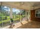 Light-filled sunroom with tile flooring, ceiling fans, and picturesque backyard views at 8725 Herons Walk, North Charleston, SC 29420