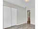 Bedroom with wood-look flooring, a double door closet, and view of bathroom at 9016 Greenbriar Dr, Summerville, SC 29485