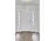 Clean and bright entryway with hardwood floors, featuring sidelights and white trim at 9016 Greenbriar Dr, Summerville, SC 29485