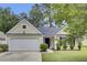 Inviting single-Gathering home featuring a well-kept lawn, attached garage, and a welcoming entrance at 9016 Greenbriar Dr, Summerville, SC 29485