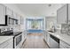 The eat-in kitchen features white cabinets and stainless steel appliances at 9016 Greenbriar Dr, Summerville, SC 29485