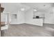 Open-concept living room with hardwood floors connecting to the kitchen area at 9016 Greenbriar Dr, Summerville, SC 29485
