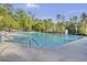 Large swimming pool surrounded by trees and lounge chairs with blue ladder entry and black metal fence at 9016 Greenbriar Dr, Summerville, SC 29485