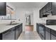 Updated kitchen featuring stylish black cabinets, modern appliances, and tiled floors at 902 Greenmeadow Dr, Goose Creek, SC 29445
