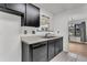 Updated kitchen featuring stylish black cabinets, modern appliances, and tiled floors at 902 Greenmeadow Dr, Goose Creek, SC 29445