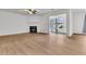 Bright living room featuring wood floors, a ceiling fan, and a fireplace with black tile at 902 Greenmeadow Dr, Goose Creek, SC 29445