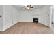 Living room showcasing wood floors, a ceiling fan, and a fireplace with a white mantle at 902 Greenmeadow Dr, Goose Creek, SC 29445