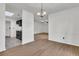 Open-concept living room and kitchen with modern lighting and wood-style flooring; tiled kitchen entryway at 902 Greenmeadow Dr, Goose Creek, SC 29445