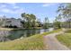 Scenic view of waterfront property showing buildings, trees, and an idyllic walking path at 902 Greenmeadow Dr, Goose Creek, SC 29445