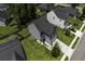 An aerial view of a two-story home featuring a well-manicured lawn, mature trees, and neutral siding at 9680 Spencer Woods Rd, Ladson, SC 29456