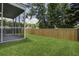 A well maintained and fully fenced green backyard with lawn and mature trees offers privacy at 9680 Spencer Woods Rd, Ladson, SC 29456
