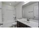 Bathroom with a tub-shower combo with a shower curtain, white countertop, and dark wood cabinets at 9680 Spencer Woods Rd, Ladson, SC 29456