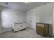 Cozy Bedroom with a white crib, double door closet, neutral carpet, and a wood dresser at 9680 Spencer Woods Rd, Ladson, SC 29456