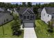 Exterior view of home with two-car garage, manicured front lawn, and mature trees at 9680 Spencer Woods Rd, Ladson, SC 29456