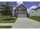 Charming two-story home featuring a two-car garage, well-kept lawn, and attractive landscaping at 9680 Spencer Woods Rd, Ladson, SC 29456
