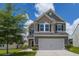 Charming two-story home featuring a well-maintained lawn and attached two-car garage at 9680 Spencer Woods Rd, Ladson, SC 29456