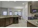 Open-concept kitchen with granite countertops, stainless steel appliances, and access to the dining area at 9680 Spencer Woods Rd, Ladson, SC 29456