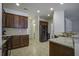 Beautiful kitchen featuring granite countertops, dark cabinets, and a view into the bathroom at 9680 Spencer Woods Rd, Ladson, SC 29456