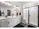 Modern bathroom with double vanity, walk-in shower, and sleek black and white finishes at 102 Bolsena Ct, Summerville, SC 29486