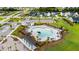 Aerial view of the community pool featuring lounge areas, pergolas, and manicured landscaping at 102 Bolsena Ct, Summerville, SC 29486