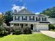Charming two-story home with gray siding, black shutters, a green lawn, and a two car garage at 1039 Steelechase Ln, Hanahan, SC 29410
