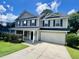 Well-maintained two-story home with gray siding, black shutters, green lawn, and a two car garage at 1039 Steelechase Ln, Hanahan, SC 29410