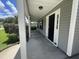Charming covered front porch with white columns, a black front door, and views of the front yard at 1039 Steelechase Ln, Hanahan, SC 29410