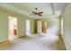 Generously sized main bedroom with a ceiling fan, plush carpeting, and adjacent bathroom and closet access at 1039 Steelechase Ln, Hanahan, SC 29410