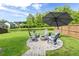 Backyard with patio firepit area, green grass, and a view of trees at 105 Plowden Mill Ct, Summerville, SC 29485