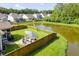 A beautiful backyard with a pond view and an outdoor seating area with a fire pit at 105 Plowden Mill Ct, Summerville, SC 29485