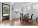 Bright dining room with wainscoting, a glass table, and a view of the outdoors, creating a perfect gathering space at 105 Plowden Mill Ct, Summerville, SC 29485