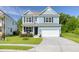 Beautiful two-story home featuring blue siding, a welcoming front porch, and a well-maintained lawn, exuding curb appeal at 105 Plowden Mill Ct, Summerville, SC 29485