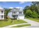 Charming two-story home with a well-manicured lawn, a cozy front porch, and a spacious driveway leading to the garage at 105 Plowden Mill Ct, Summerville, SC 29485