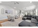 Light-filled living room adjacent to staircase features neutral decor and hardwood floors at 105 Plowden Mill Ct, Summerville, SC 29485