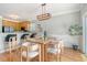 Bright dining area with modern lighting fixture, stylish table and chairs, and kitchen access at 1052 Whitlow Blvd, Summerville, SC 29483