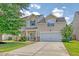 Charming two-story home with a well-manicured lawn, a two-car garage, and inviting curb appeal at 1052 Whitlow Blvd, Summerville, SC 29483