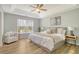 Bright primary bedroom with a tray ceiling, wood floors and a sitting area at 1052 Whitlow Blvd, Summerville, SC 29483