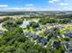 Aerial view of the community with pond, mature trees and homes in the background at 1070 Moss Grove Dr, Moncks Corner, SC 29461
