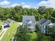 Aerial view of a blue home with a detached garage in a neighborhood with mature trees at 1070 Moss Grove Dr, Moncks Corner, SC 29461