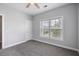 Cozy bedroom with a large window for natural light, neutral walls, gray carpet, and ceiling fan at 1070 Moss Grove Dr, Moncks Corner, SC 29461