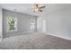 A bright, open bedroom features two windows, neutral colors, and plush carpet at 1070 Moss Grove Dr, Moncks Corner, SC 29461