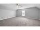 Neutral bedroom featuring gray carpet, a large window, and ceiling fan at 1070 Moss Grove Dr, Moncks Corner, SC 29461