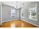 Dining room featuring shiny hardwood floors, modern lighting, and bright windows at 1070 Moss Grove Dr, Moncks Corner, SC 29461