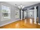 Dining room with hardwood floors, architectural columns, modern lighting, and natural light at 1070 Moss Grove Dr, Moncks Corner, SC 29461