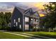 Inviting home featuring attractive siding, well-manicured lawn, and a charming double balcony at sunset at 1070 Moss Grove Dr, Moncks Corner, SC 29461