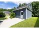 Detached garage with side entrance and concrete driveway surrounded by green grass at 1070 Moss Grove Dr, Moncks Corner, SC 29461
