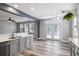 Bright kitchen area with a sink, stylish cabinets, and a door to the backyard at 1070 Moss Grove Dr, Moncks Corner, SC 29461