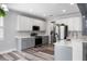 Spacious kitchen with two-tone cabinets, stainless steel appliances, and luxury vinyl flooring at 1070 Moss Grove Dr, Moncks Corner, SC 29461